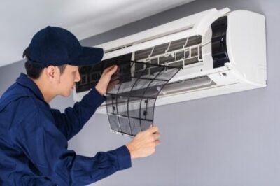 technician service Man removing air filter for air conditioner cleaning